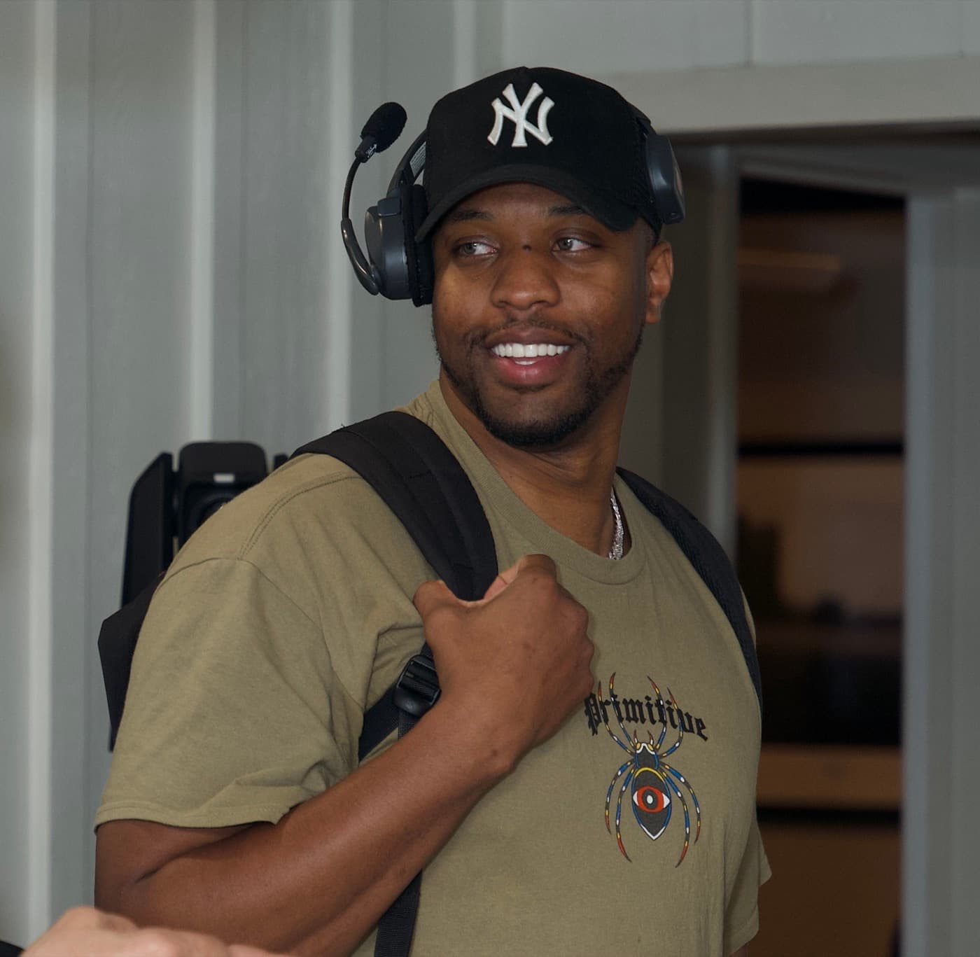 High Arc Media crew member on a production headset on set